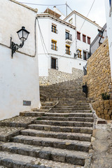 Street view of a narrow street of Altea, Spain