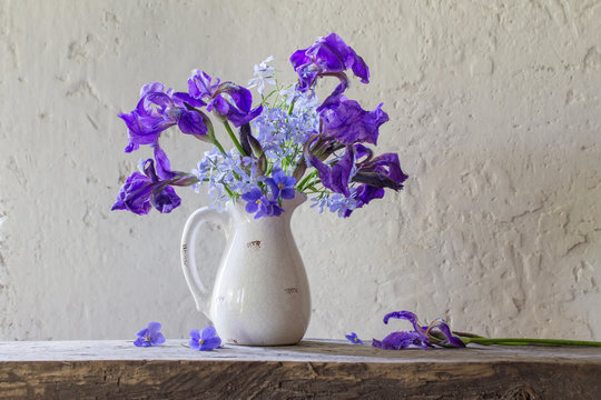beautiful bouquet with irises on wooden table