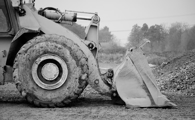 Big excavator tire side view closeup in black and white