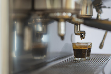 Prepares espresso in his coffee shop; close-up