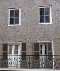 Brown And Gray Building Wall With Windows and Shutters