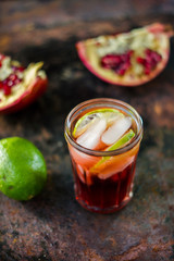 Fresh pomegranate drink - lemonade or cocktail with lime and ice