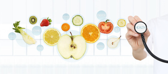 healthy food concept, Hand of nutritionist doctor pointing fruit with stethoscope