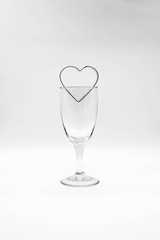 Metal heart frame over wine glass