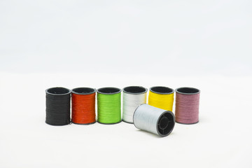 Colorful threads on white background