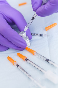 Cosmetic Surgeon Doctor Filling Botox Syringe From Vial