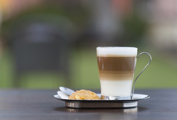 A cup of coffee on table outdoor and on nature background