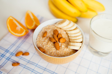 bowl of oatmeal with fruit and almonds