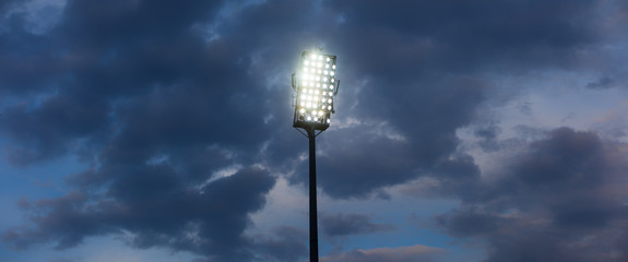 Stadium lights against dark night sky background