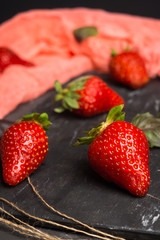 Fresh ripe strawberry on the rustic background. Shallow depth of field.