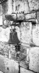 Old bell on the wall.