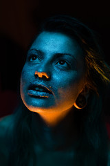 portrait of beautiful young woman with blue studio light
