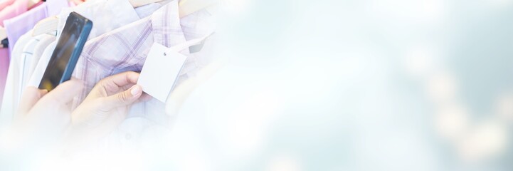 Cropped image of woman scanning bar code with her mobile phone