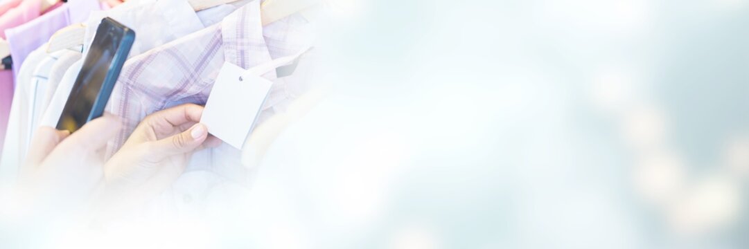 Cropped image of woman scanning bar code with her mobile phone