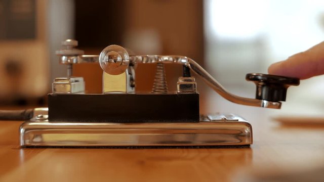 Morse code transmitter being used, communication old style, side angle