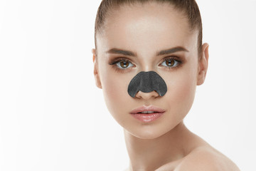 Fototapeta premium Cosmetology. Beautiful Female With Black Mask On Nose