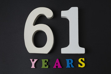 Letters and numbers-sixty-one on a black background.