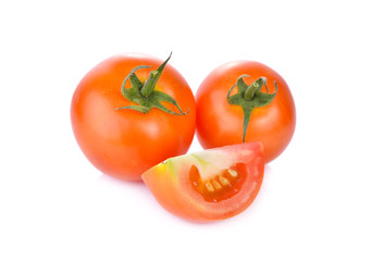 whole and portion cut fresh tomato on white background