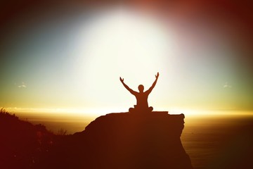 Composite image of silhouette businessman with arms raised 