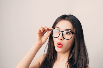 Young beautiful Asian woman with smiley face wearing glasses.
