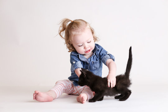 Cute Toddle Girl Plays With Baby Kittens