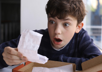 teenager boy shocked expression after see bill for pizza in fast food restaurant