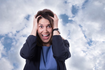 Stress. Woman stressed is going crazy pulling her hair in frustration.