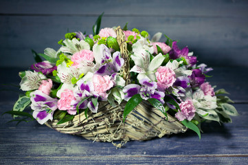Fototapeta na wymiar Wedding bouquet in basket on wooden background. Vintage toning