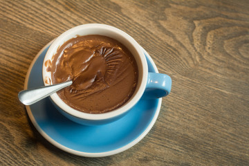 Blue Cups of hot Chocolate drink on dark wooden background. Morning time. Holiday concept