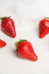 Fresh ripe strawberry on the rustic background. Shallow depth of field.