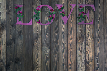 Inscription love on a wooden wall, letter love, copy space