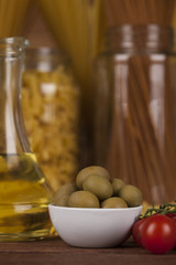 Dry pasta with ingredients on a old wood