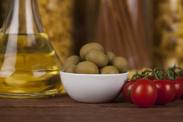 Dry pasta with ingredients on a old wood