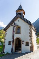 Fototapeta na wymiar Landscape protection area Achstürze. Blasius chapel in Oetz-Piburg, alps in background. Tirol oldest nature preserves. Oetz alps, unique cultural mountains landscape, Lake Piburger See, Ötztal valley.