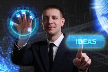 Business, Technology, Internet and network concept. Young businessman working on a virtual screen of the future and sees the inscription: Ideas