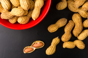 Peanuts in shell on dark background, close up