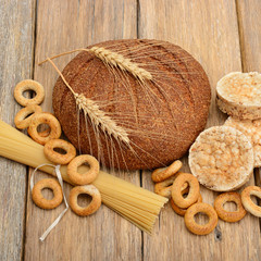 bread, pasta and pastries on wooden surface