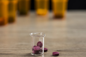 Red pills inside beaker
