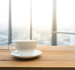 Coffee cup with window city view in the morning