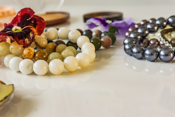 Beautiful bracelets made of pearls and natural stones on the white background. Soft defocus in Depth.