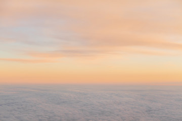 Fototapeta na wymiar beautiful sunset above the clouds from aircraft