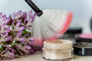 Close-up of mineral eye shadow hailayter,  pressed shadows, and brush to apply the high-sheen....