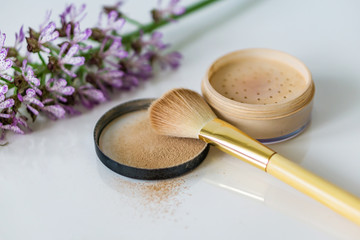 Close-up of mineral, powder, foundation makeup and brush to apply the product. 
