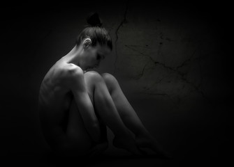 Naked woman in shadow posing