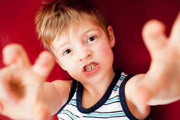Young boy acting like a monster