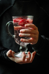  Strawberry slices in lemonade (transparent glass in hands) a lot of bubbles