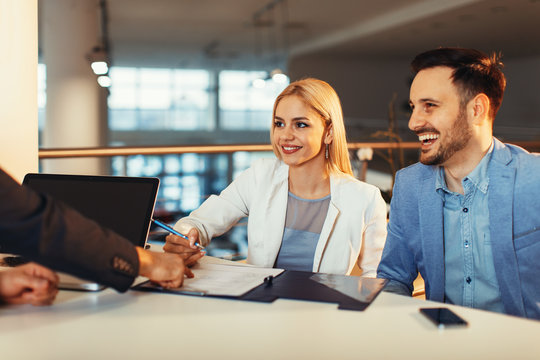 Young Business Couple Signing A Contract