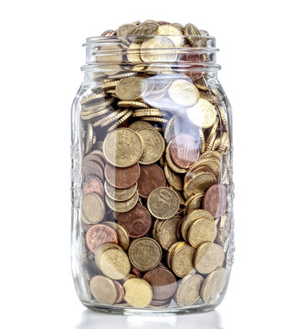  classic glass jar used for canned food filled with euro coins. Concept of family economy and savings.