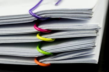 Multicolored paper clips on paperwork