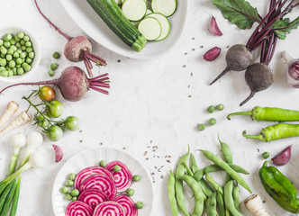 Fototapeta na wymiar Organic purple and green vegetables on a white background. Detox ingredients. Healthy, vegetarian food concept. Top view, free space for text. Flat lay
